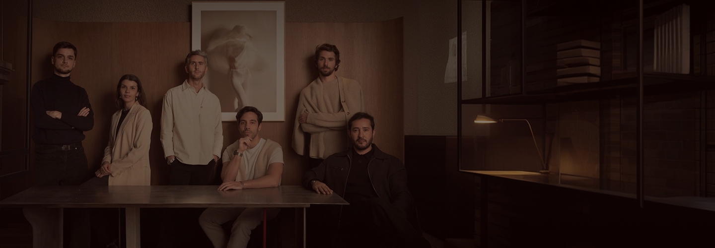 A boutique professional team gathered in a warmly lit studio